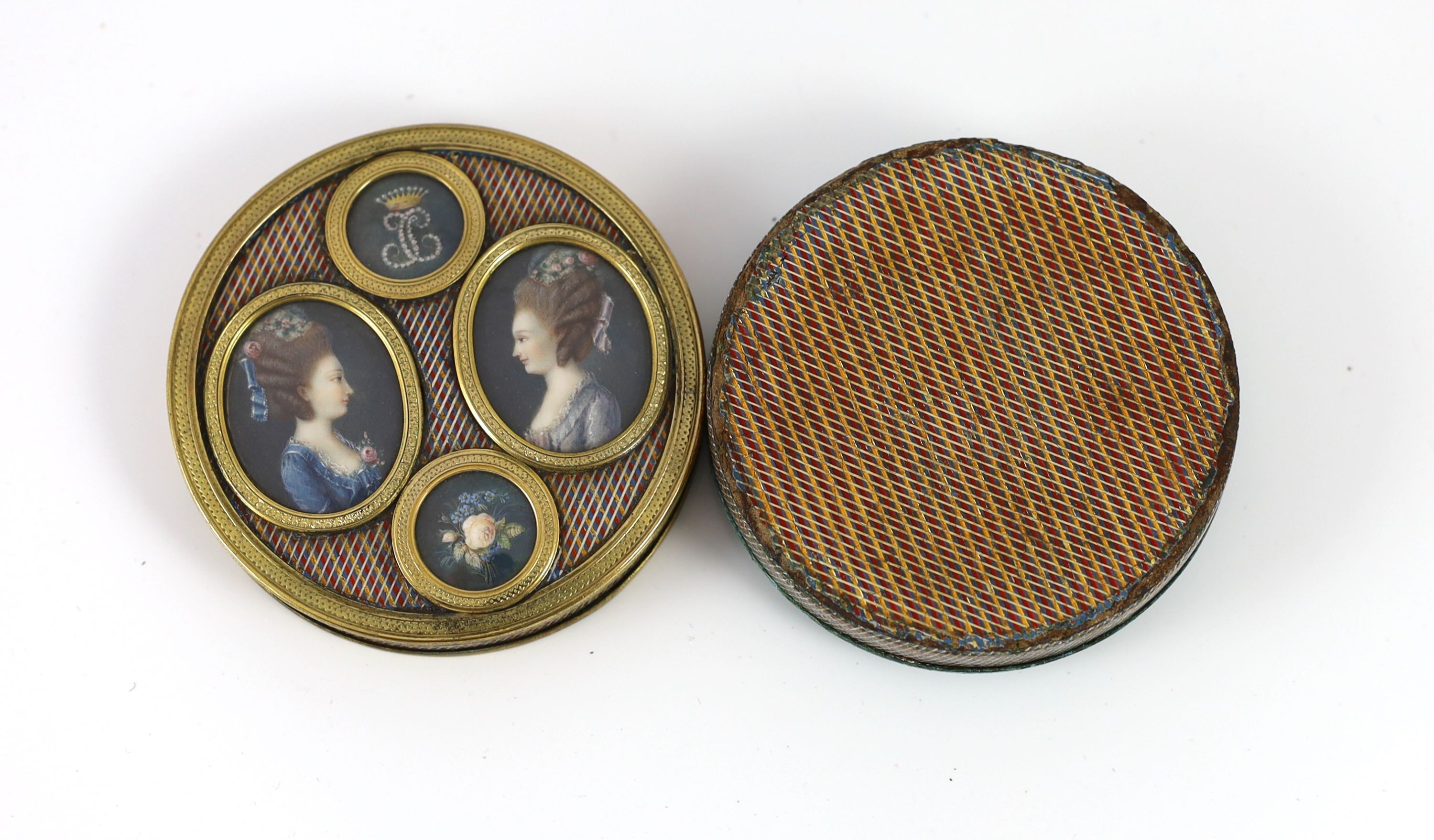 A late 18th century tortoiseshell poudre d'écaille box, the cover inset with two portraits of young ladies, below a monogram ‘JC’ with coronet, mounted in gilt metal 8cm diameter